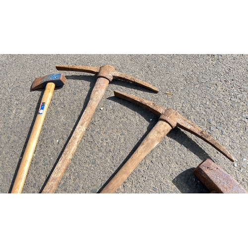 36 - An assortment of tools, to include pick axe, sledge hammers & more.
