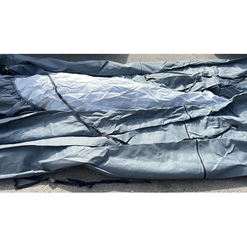 50 - A grey woven synthetic protective cover with black webbing tie-down straps.