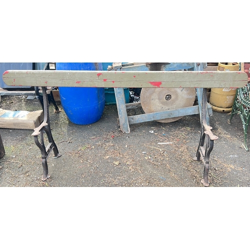 60 - Cast-iron based bench with a shaped timber seat rail, the side supports cast in relief 'J P Correy  ... 