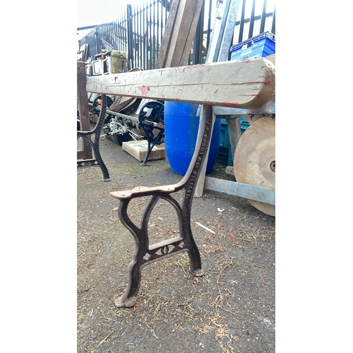 60 - Cast-iron based bench with a shaped timber seat rail, the side supports cast in relief 'J P Correy  ... 