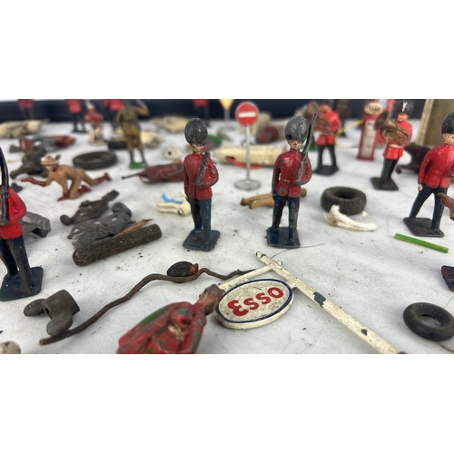 144 - A collection of painted lead and composition toy soldiers and accessories, including Guardsmen, moun... 
