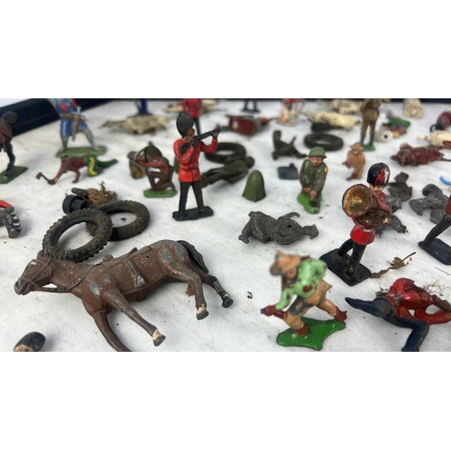 144 - A collection of painted lead and composition toy soldiers and accessories, including Guardsmen, moun... 