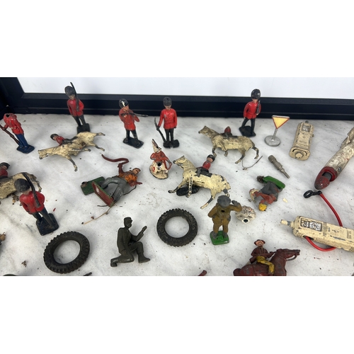 144 - A collection of painted lead and composition toy soldiers and accessories, including Guardsmen, moun... 