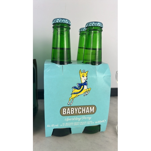 149 - Collection of Babycham, to include 2 four-bottle cartons & pair of vintage glasses.