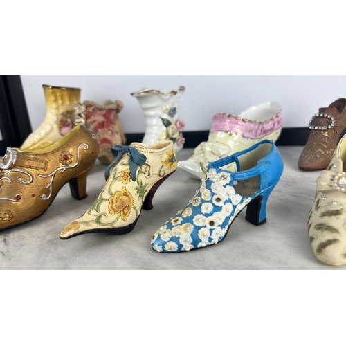 156 - A collection of shoe- and boot-form decorative ornaments, glazed ceramic and clear glass, variously ... 