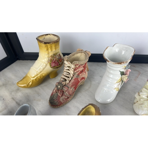 156 - A collection of shoe- and boot-form decorative ornaments, glazed ceramic and clear glass, variously ... 