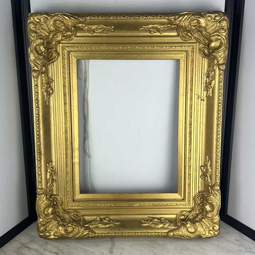 176 - Giltwood picture frame of rectangular form, the moulded border enriched with beading and foliate str... 