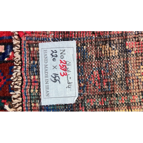 Hand-knotted Persian-style wool rug with two joined lozenge medallions ...