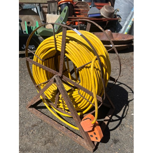 52 - A large extension lead on a cast iron reel stand.