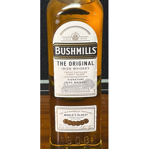24 - Bushmills “The Original” Irish whiskey—signature blend, triple distilled—presented in a clear glass ... 