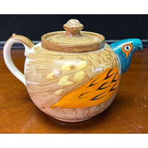 27 - Novelty glazed earthenware teapot modelled as a stylised bird, with turquoise head and beak-form spo... 