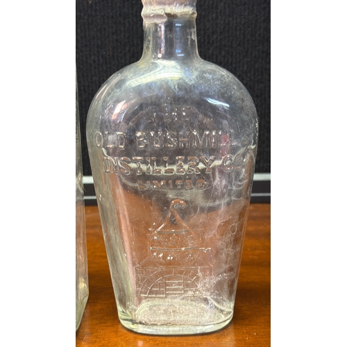 28 - A group of vintage moulded-glass bottles for The Old Bushmills Distillery Co. Limited, with embossed... 