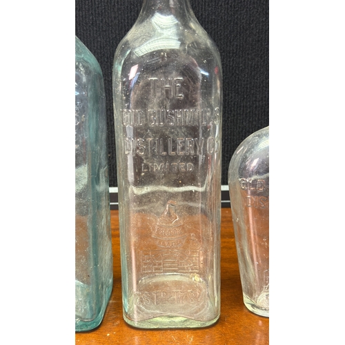 28 - A group of vintage moulded-glass bottles for The Old Bushmills Distillery Co. Limited, with embossed... 