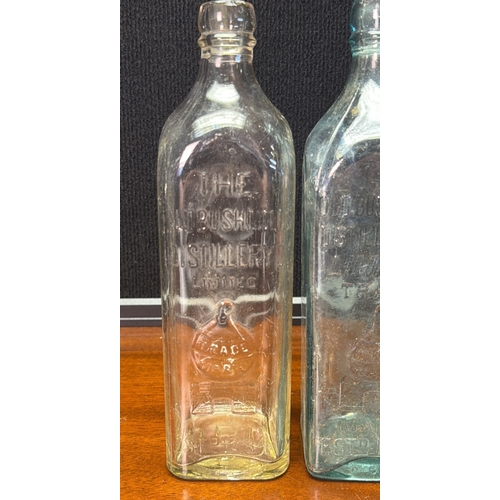 28 - A group of vintage moulded-glass bottles for The Old Bushmills Distillery Co. Limited, with embossed... 