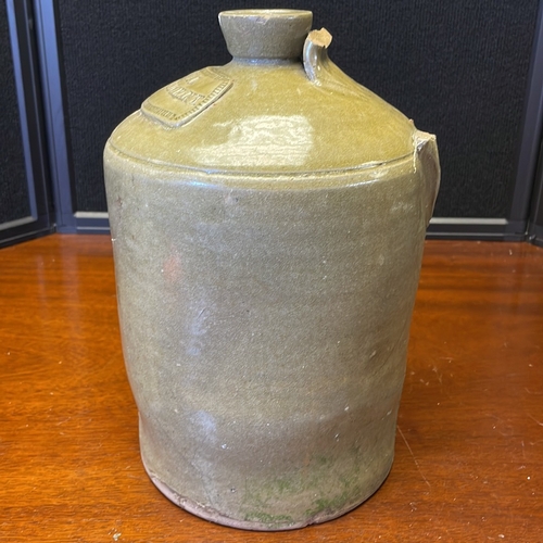 57 - Stoneware spirit flask or jug, of cylindrical body with rounded shoulders and short collar neck, the... 