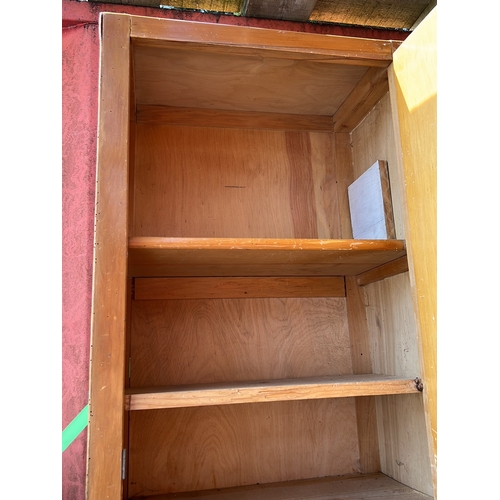 2 - 20th century tall wooden cabinet, the plain door with surface-mounted hinges and swing handle, enclo... 