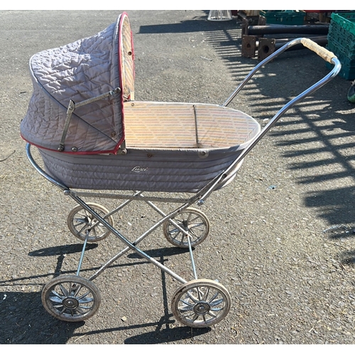 29 - A group of vintage infant and toddler equipment comprising a metal bodied pram with quilted hood on ... 
