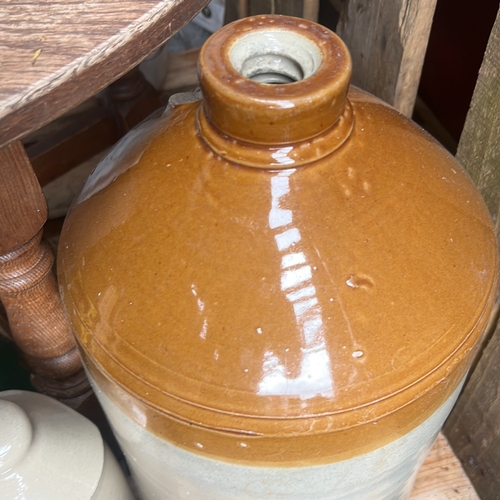 64 - Two stoneware vessels comprising a large shouldered storage jar with honey-glazed shoulder and colla... 