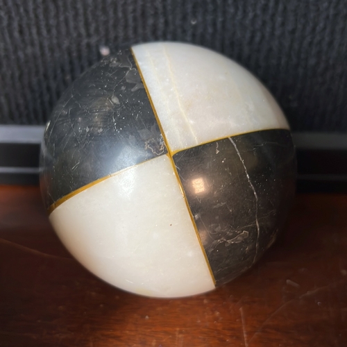 A group of polished stone decorative objects: a banded die with red and ...