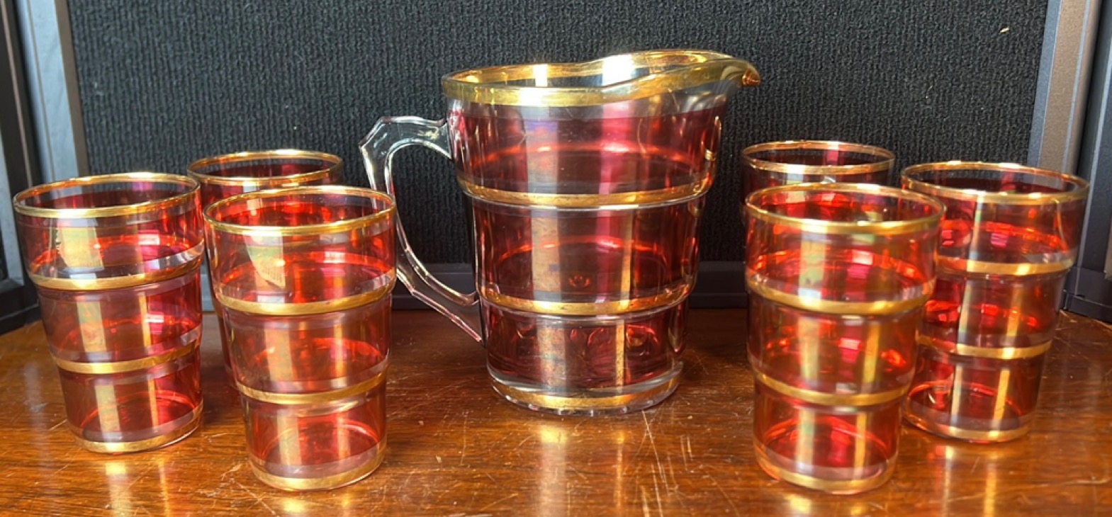 Ruby-red glass drinks set comprising a jug with clear handle and spout ...