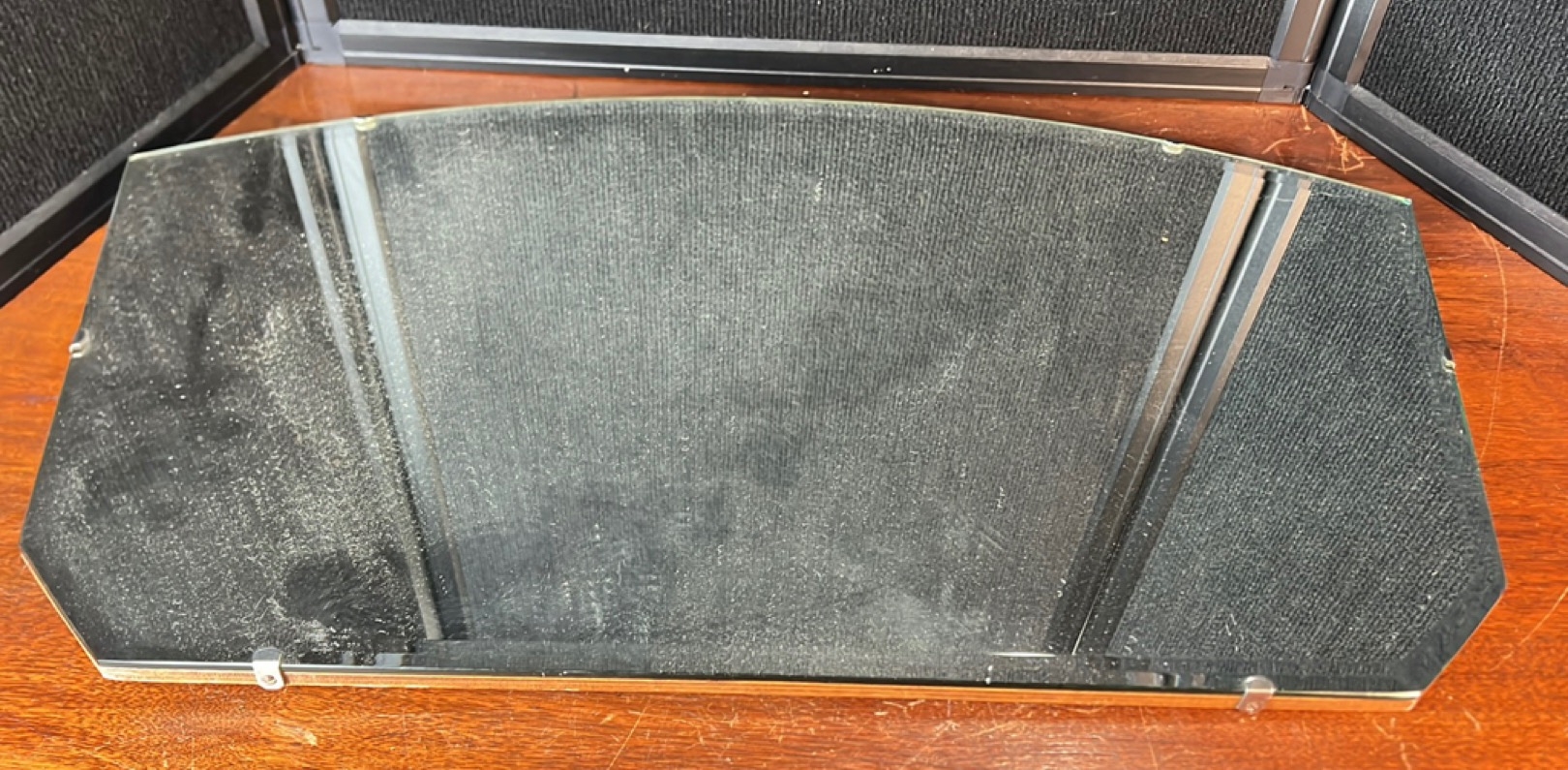 Frameless wall mirror of elongated octagonal form, the bevelled plate ...