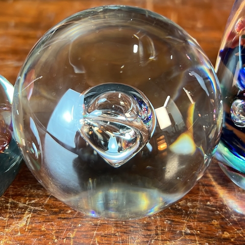 A group of four glass paperweights: an ovoid example with cobalt-blue ...