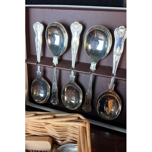 A collection of table cutlery, including boxed shell-pattern spoons, a ...
