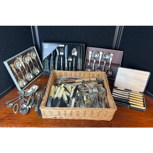 A collection of table cutlery, including boxed shell-pattern spoons, a ...