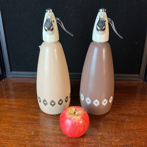 A pair of BOC Sparklets soda syphons, made in England, with cream and ...