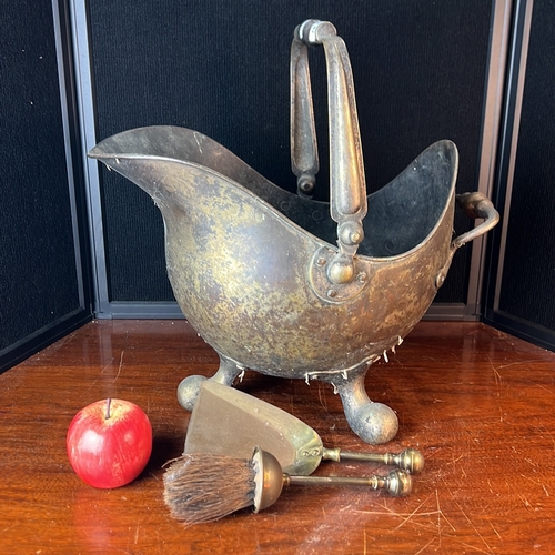 Helmet-form metal coal scuttle with a swing handle, rear grip and ball ...