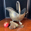 Helmet-form metal coal scuttle with a swing handle, rear grip and ball ...