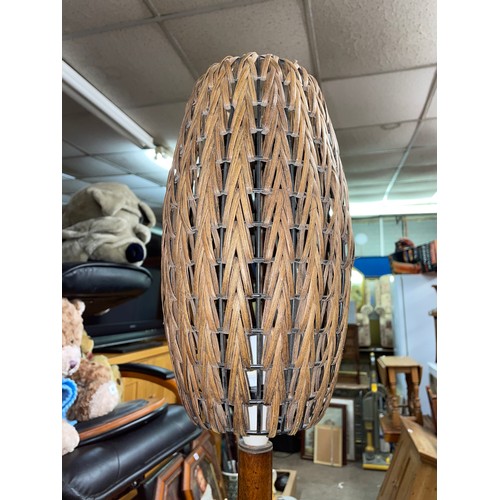 67 - WALNUT LAMP STANDARD WITH A VINTAGE WICKER OVOID SHADE