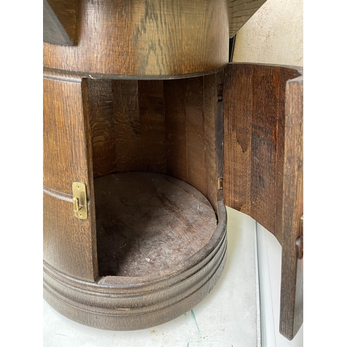 142 - OAK CIRCULAR TOPPED BARREL BASE STORAGE CUPBOARD