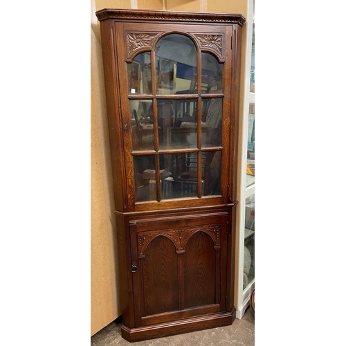 125 - OAK CARVED ARCHED GLAZED CORNER CUPBOARD