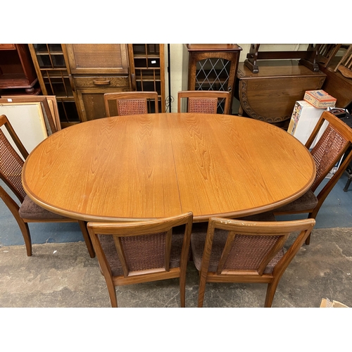 128 - G PLAN TEAK OVAL DINING TABLE AND SIX ROSEWOOD BERGERE CANED PANEL CHAIRS