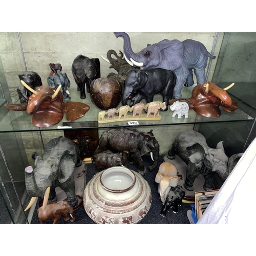 320 - TWO SHELVES OF CARVED TREEN RESIN MOULDED AND STONE ELEPHANT FIGURE GROUPS INCLUDING NOVELTY MONEY B... 