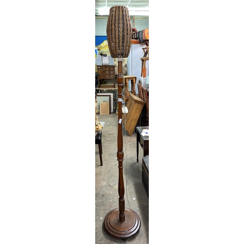 67 - WALNUT LAMP STANDARD WITH A VINTAGE WICKER OVOID SHADE