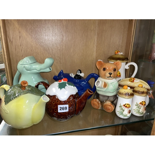 269 - SHELF OF VARIOUS NOVELTY TEAPOTS AND CONDIMENTS