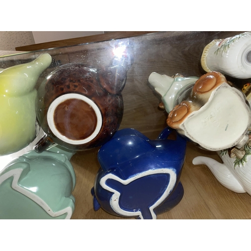 269 - SHELF OF VARIOUS NOVELTY TEAPOTS AND CONDIMENTS