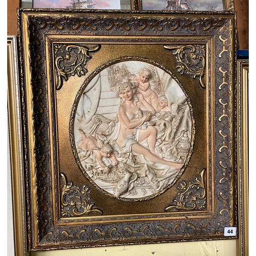 44 - BAS RELIEF PLAQUE OF CHERUBS IN AN ORNATE GILT FRAME