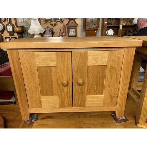 55 - CONTEMPORARY SMALL OAK TWO DOOR CANTED MEDIA CUPBOARD