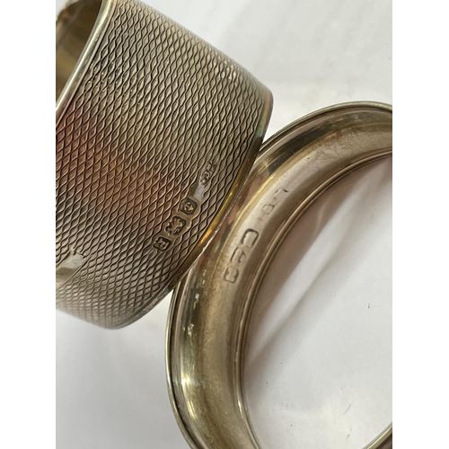 558 - THREE SILVER NAPKIN RINGS AND A SILVER SPOON 1.3OZ APPROX