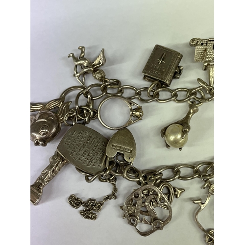 526 - SILVER CHARM BRACELET WITH HEART PADLOCK AND VARIOUS NOVELTY CHARMS 1.4OZ APPROX