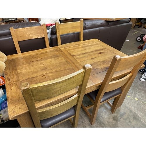 57 - MATCHING OAK EXTENDING DINING TABLE AND FOUR LADDERBACK CHAIRS