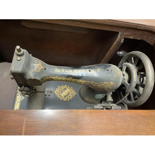 175 - EARLY 20TH CENTURY WALNUT CASED TREADLE SEWING MACHINE