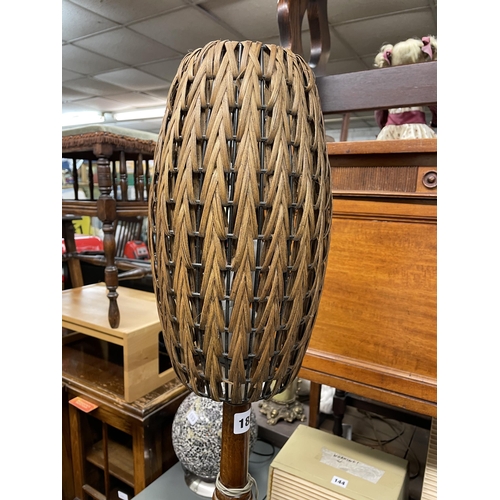 182 - WALNUT LAMP STANDARD WITH A VINTAGE WICKER OVOID SHADE