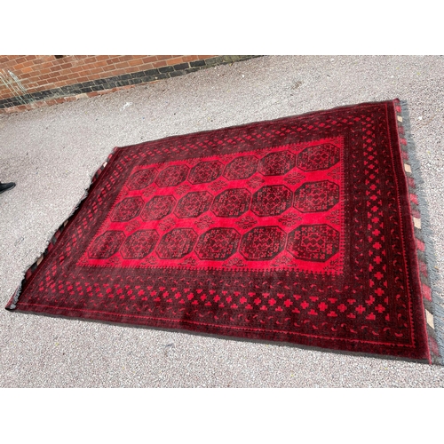 205 - LARGE RED AND BLACK FRINGED CARPET 292CM X 205CM