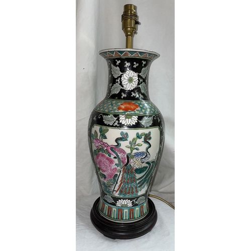 608 - REPRODUCTION CHINESE BALUSTER POTTERY TABLE LAMP DECORATED WITH FLOWERS ON A BLACK GROUND