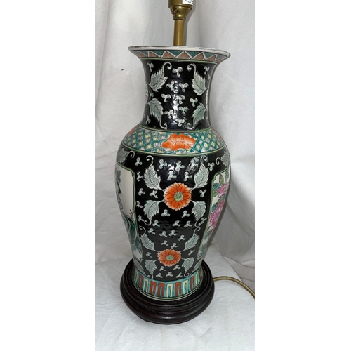 608 - REPRODUCTION CHINESE BALUSTER POTTERY TABLE LAMP DECORATED WITH FLOWERS ON A BLACK GROUND