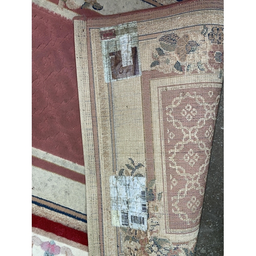 77 - PINK PATTERED CARPET RUNNER AND A DEEP RED SMALL RUG